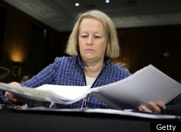 Chairman of the Securities and Exchange Commission Mary Schapiro gathers her papers prior to a hearing before the Senate Agriculture, Nutrition and Forestry Committee December 1, 2011 on Capitol Hill in Washington, DC. The committee held a hearing on 'Continuing Oversight of the Wall Street Reform and Consumer Protection Act.' (Getty)