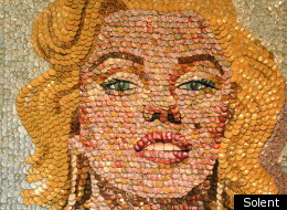 Molly Right attaches the bottle tops to the paintings in a 'snake scale' pattern