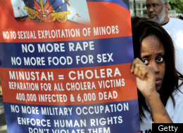 A woman holds a sign as she demonstrates against the U.N. mission in Haiti to protest sexual violence and the cholera transported to Haiti on Sept. 19, 2011 across from the U.N. headquarters in New York.