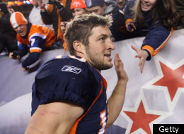DENVER, CO - JANUARY 08: Quarterback Tim Tebow #15 of the Denver Broncos receives high fives from fans after defeating the Pittsburgh Steelers in overtime of the AFC Wild Card Playoff game at Sports Authority Field at Mile High on January 8, 2012 in Denver, Colorado. The Broncos defeated the Steelers in overtime 23-29. (Photo by Jeff Gross/Getty Images)
