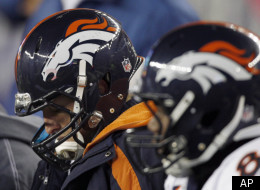 Denver Broncos quarterback Tim Tebow, left, sits on the bench during the second half of an NFL divisional playoff football game against the New England Patriots Saturday, Jan. 14, 2012, in Foxborough, Mass. (AP Photo/Charles Krupa)