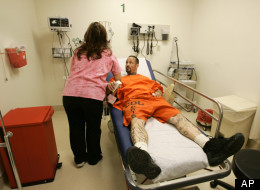 Inmate Jay Allen Herman, 37, of Middletown, Calif., right, gets treated for a diabetic condition by Dulcelena Solorio, a registered nurses in the new Triage and Treatment Area at San Quentin State Prison in San Quentin, Thursday, June 14, 2007. The federal receiver who controls California's inmate medical system opened a new $1.6 million emergency room for San Quentin State Prison's 6,000 inmates Thursday, offering it as a model for the expensive modernization he said is needed throughout the na
