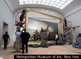 Staff at the Metropolitan Museum of Art hang the newly framed and restored