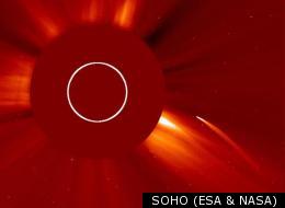 A 'sun-grazing' comet as caught by SOHO's LASCO C2 camera. The sun's bright light is itself blocked out by a coronograph