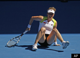 Belgium's Kim Clijsters falls over during her fourth round match against China's Li Na at the Australian Open tennis championship in Melbourne, Australia, Sunday, Jan. 22, 2012. (AP Photo/Aaron Favila)