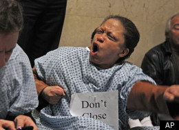 Matt Ginsberg Jaeckle, left, and Gail Davis, protesters with the Mental Health Movement, stage a sit-in outside the office of Chicago Mayor Rahm Emanuel, Tuesday, Nov. 15, 2011, in Chicago. The dozen or so protesters accompanied by several dozens more supporters from various groups, oppose Emanuel's proposed budget, which would close six of the city's 12 mental health clinics and partner the city's neighborhood health clinics with a federal program. (AP Photo/M. Spencer Green)