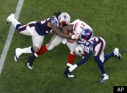 New England Patriots' Brandon Spikes, left, and Devin McCourty, right, tackle New York Giants running back Brandon Jacobs in the first quarter of an NFL football game in Foxborough, Mass., Sunday, Nov. 6, 2011. (AP Photo/Michael Dwyer)