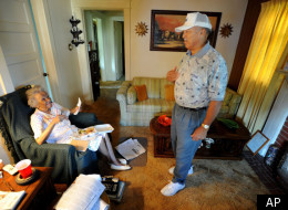 Matt Jackson, right, of the Meals On Wheels program in Charleston, W.Va., delivers a meal to Mary Elliott, 91, at her home Wednesday, June 25, 2008 in Charleston, W.Va. Rising gas and food prices and federal budget cuts are crippling programs that many older Americans rely on for food, transportation and contact with the outside world. (AP Photo/Jeff Gentner)