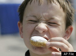 P.J. Stokes bites into a deep-fried Reeses's at the Indiana State Fair in Indianapolis, Wednesday, Aug. 8, 2007. All of the deep-fried goodies are being cooked in oil free of the trans fats linked to obesity, heart disease and diabetes. Indiana is the first state to make the switch at its fair. (AP Photo/Darron Cummings)