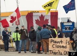 CAW workers picket outside at the Electro-Motive plant in London, Ont., on Friday, feb. 3, 2012. American-based heavy equipment maker Caterpillar Inc. announced Friday it was closing the plant, a month after it locked out about 450 workers. THE CANADIAN PRESS/Mark Spowart