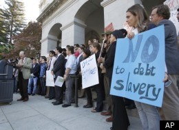 University of California students and student leaders from UC Berkeley and UC Davis protesting tuition hikes listen to Berkeley professor and provost George Breslauer speak speak during a news conference at the Capitol in Sacramento, Calif., on Wednesday, Nov. 16, 2011. (AP Photo/Steve Yeater)