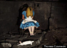 Lifeless: Alice is no longer in Wonderland...slumped in her chair with the white rabbit lying dead at her feet