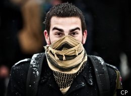 A student protests in front of the Hilton hotel in Quebec City.