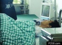 Zhu in the hospital, just moments before he escaped and jumped off a hotel.