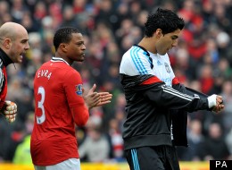 Patrice Evra goes to confront Luis Suarez after the Uruguayan refused to shake his hand prior to Manchester United's clash with Liverpool
