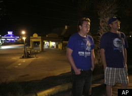 In this Thursday, Feb. 9, 2012 photo, Zach, left, and Ronald Montgomery stand near the motel they live in Clermont, Fla. The gas station behind them is one of the few places to buy goods within walking distance of their motel. Here in Lake County the number of homeless students has skyrocketed, from 122 in 2005 to more than 2,600 this school year. It's the largest increase in hard hit Florida and echoes the rising numbers seen nationwide as well.