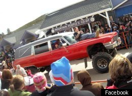 A red hearse cruises through the annual hearse parade at Frozen Dead Guy Days.
