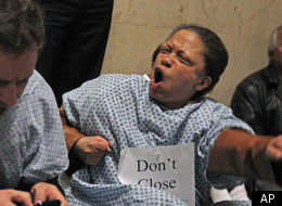 Matt Ginsberg Jaeckle, left, and Gail Davis, protesters with the Mental Health Movement, stage a sit-in outside the office of Chicago Mayor Rahm Emanuel, Tuesday, Nov. 15, 2011, in Chicago. The dozen or so protesters accompanied by several dozens more supporters from various groups, oppose Emanuel's proposed budget, which would close six of the city's 12 mental health clinics and partner the city's neighborhood health clinics with a federal program. (AP Photo/M. Spencer Green)