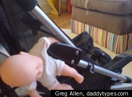 A Maclaren stroller with a doll caught in the closing mechanism, created by Greg Allen of <a href=