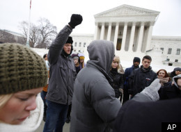 Anti-abortion protesters pray outside the U.S. Supreme Court during the annual