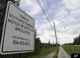 In this photo taken Tuesday, July 26, 2011, a sign is posted at the site for a proposed detention center to be built in Southwest Ranches, Fla.