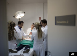 In this photo taken Wednesday March 14, 2012, Barbara Penha receives a free of charge radio-frequency treatment on her abdomen by Doctor Nelson Rosas, at the Brazilian Society of Aesthetic Medicine clinic in Rio de Janeiro, Brazil. (AP)
