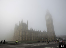Fog shrouds the clock tower which houses the 'Big Ben' bell of the Palace of Westminster, as Westminster Bridge stands at right in London, Thursday, March 15, 2012. (AP)