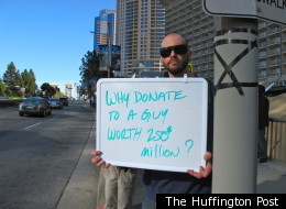 Redondo Beach resident Jay, 33, changed his sign's message throughout Tuesday's anti-Mitt Romney rally.