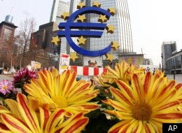 The European Union is considering a financial transactions tax in order to pay for the 2008 bank bailouts. In this photo, flowers are seen near the Euro sculpture in front of the European Central Bank in Frankfurt, Germany, Wednesday, March 7, 2012.