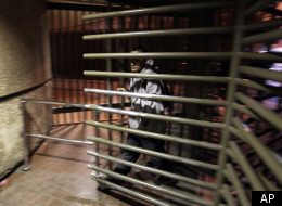 In this Feb. 1, 2012 photo, a man walks through a turnstile on his way to cross into the United States from Mexicali, Mexico, in Calexico, Calif. (AP Photo/Gregory Bull)