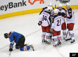 The Columbus Blue Jackets celebrate a goal by Rick Nash as Colorado Avalanche defenseman Shane O'Brien, left, kneels on the ice in the second period of an NHL hockey game on Thursday, April 5, 2012, in Denver. (AP Photo/Chris Schneider)