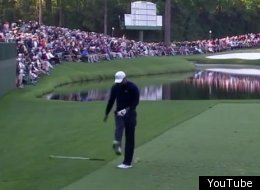 Tiger Woods kicks his club in frustration during the Masters at Augusta National.