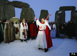 Druids take part in the winter solstice at Stonehenge in Wiltshire in the snow.