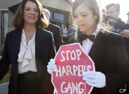Brigette DePape, the rogue page who held up a 'Stop Harper' sign in the House of Commons, protested at the polling station where Alberta Wildrose Party leader Danielle Smith voted on April 23, 2012. (CP)