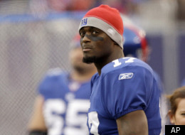 In this Nov. 16, 2008 file photo, New York Giants wide receiver Plaxico Burress (17) watches from the sidelines against the Baltimore Ravens during the first half of an NFL football game in East Rutherford, N.J. The former Super Bowl star with the Giants, recently released from prison after serving 20 months on a gun charge, reached an agreement in principle Sunday, July 31, 2011, on a one-year deal with the New York Jets. (AP Photo/Rob Carr, File)