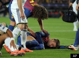 FC Barcelona's Gerard Pique', bottom right, lies on the pitch after colliding with Chelsea's Didier Drogba, left, during a Champions League 2nd leg semifinal soccer match at the Camp Nou, in Barcelona, Spain, Tuesday, April 24, 2012. (AP Photo/Felice Calabro')