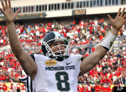 Michigan State quarterback Kirk Cousins celebrates his fourth-quarter touchdown pass to wide receiver Keith Nichol during the Outback Bowl on Jan. 2, 2012.