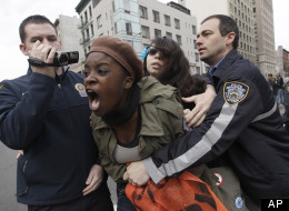 Police officers detain a couple of Occupy Wall Street activists during a march to call for NYPD Police Commissioner Ray Kelly's immediate resignation, Saturday, March 24, 2012 in New York. (AP Photo/Mary Altaffer)
