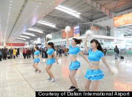 An airport in China brought in cheerleaders to keep passengers calm after a fog stranded 5,000 people.