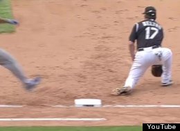 Dodgers' Jerry Hairston is called out at first despite Rockies' Todd Helton significantly missing the base.