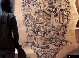 A German tattoo artist draws world news on a calfskin