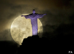 The supermoon as seen behind the Christ the Redeemer statue, Rio de Janeiro, Brazil