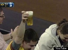 A fan catches a foul ball in his beer during the Padres game on Tuesday night.
