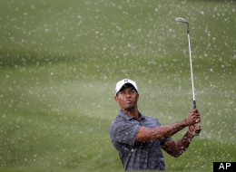 Tiger Woods watches his shot from a 10th hole bunker during the first round of the Players Championship golf tournament, Thursday, May 10, 2012, at Sawgrass in Ponte Vedra, Fla. (AP Photo/Chris O'Meara)