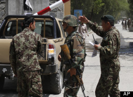Afghan National Army soldiers secure the gate of the military hospital after Arsala Rahmani, a former Taliban official turned Afghan peace negotiator, was killed by an unknown attacker in western Kabul, Sunday, May 13, 2012. (AP Photo/Rahmat Gul)