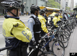 Chicago Police bicycle units officers block the entrance to a Bank of America branch while about 50 Occupy Chicago activists gather outside, as part of a May Day demonstration, Tuesday, May 1, 2012, in Chicago. The May Day protests were considered to be a preview of what to expect during the NATO summit in Chicago. (AP Photo/M. Spencer Green)