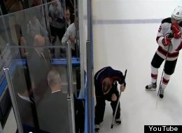 New Jersey's Travis Zajac waits as an MSG employee fixes the penalty box door.