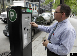 In this May 28, 2009 file photo, Sicilia Giovanni, of Chicago, feeds one of Chicago's new parking meters in Chicago. Chicago's parking meter deal was heavily criticized when it was approved in 2008. (AP Photo/Charles Rex Arbogast, File)