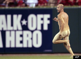 A man runs on the field before the start of the seventh inning of a baseball game between the St. Louis Cardinals and the Philadelphia Phillies Thursday, May 24, 2012, in St. Louis. (AP Photo/Jeff Roberson)