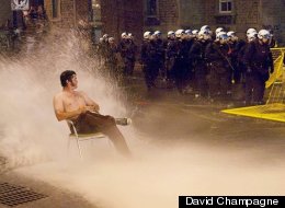 A photo of Cameron Collie, taken by David Champagne, sitting in the spray from a fire hydrant during protests in Montreal, Quebec is going viral online. (<a href=